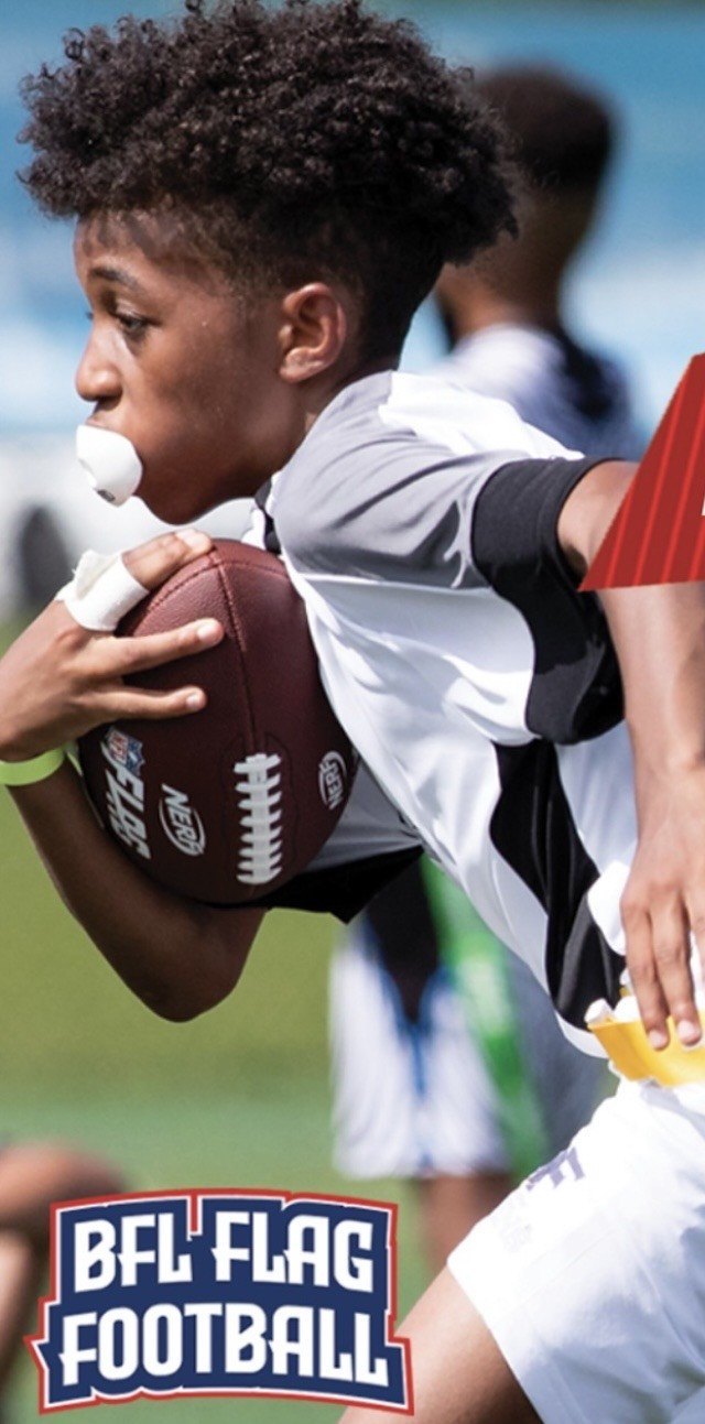 Young flag football player running the ball upfield