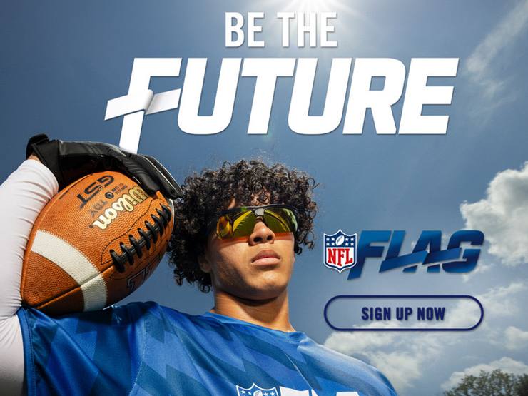 Young NFL FLAG football player holding a football