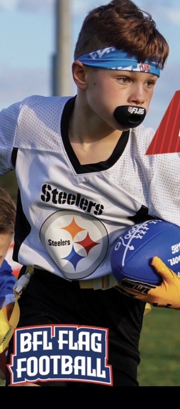 Flag football player running with the ball, no pads or helmet